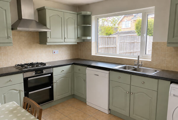 Muted blue kitchen cupboards after painting in Dunstable