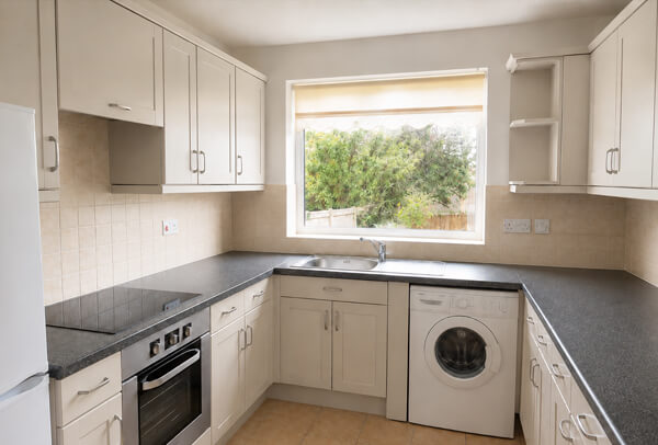 Soft warm grey painted kitchen cupboards after repainting in Dunstable