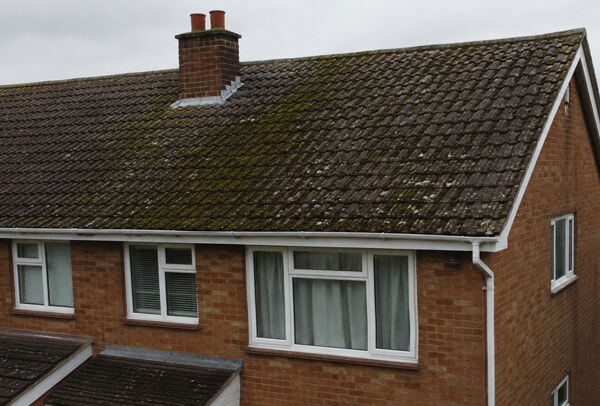 Bedford roof before cleaning with moss and staining on older roof tiles