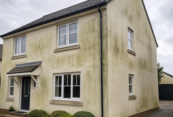 Rendered exterior wall in Bedford before cleaning with marks that make it look ready for repainting