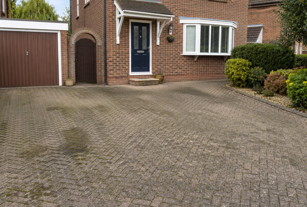 Bedford driveway before cleaning with moss, algae and dull surface build-up
