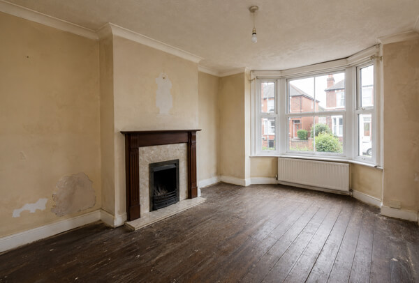 Interior room in Bedford before decorating, with tired walls and an older finish