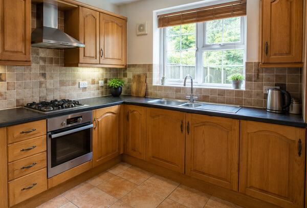 Kitchen cupboards in Bedford before painting, with an older and more dated look