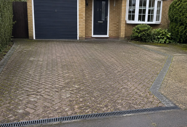 Driveway surface in Bedford before cleaning with dull paving and everyday grime