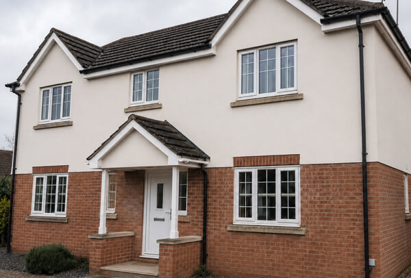 Bedford house exterior after cleaning lower walls, porch details and stained side areas
