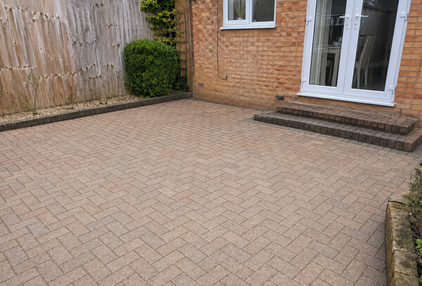 Green block paving patio in Luton before cleaning