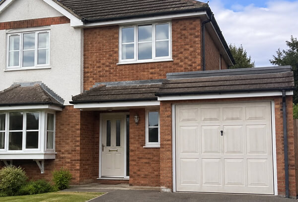 Composite garage door in Luton before painting, with an older faded colour