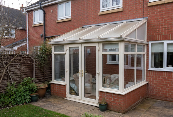 Older white conservatory frames before painting in Aylesbury