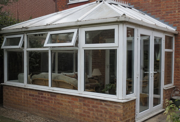 Conservatory in Northampton before painting, with faded frames and an older-looking finish
