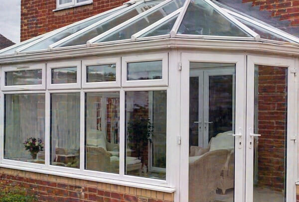 Conservatory in Northampton before painting, with tired and dated frames