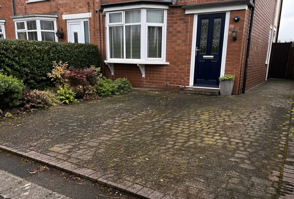 Driveway in Northampton before cleaning, with dark staining, moss and built-up surface dirt