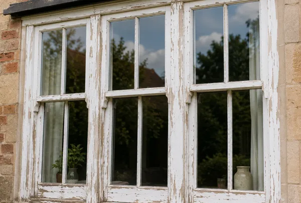 Window frames before painting with a tired outside finish