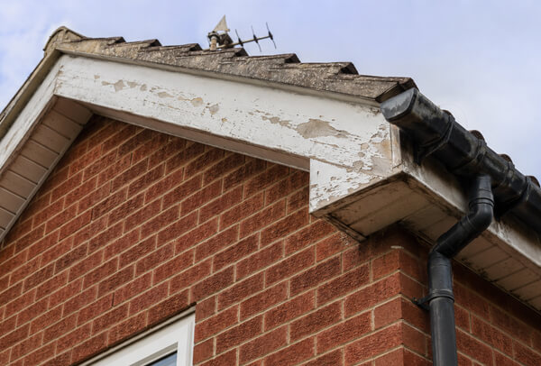 Bedford roofline before painting with faded fascia soffit gutter and bargeboard details