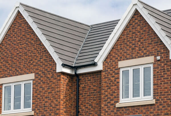 Roofline in Northampton before painting, with tired fascias, soffits and guttering