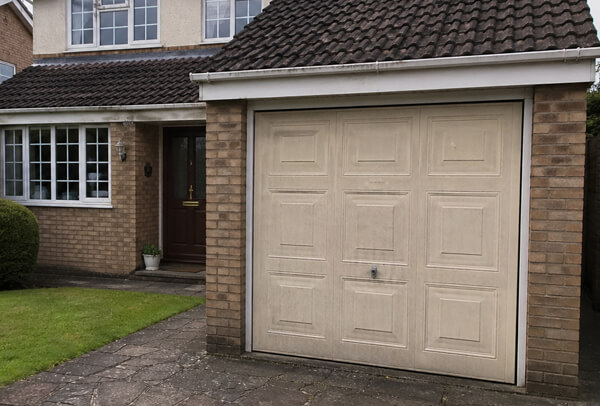 Fibreglass garage door in Luton before painting, with fading and surface wear