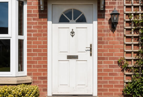 Front door in Northampton before painting, with a faded and weathered finish