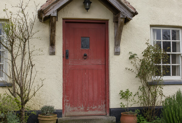 Front door before painting, with a colour that does not match the surrounding exterior features
