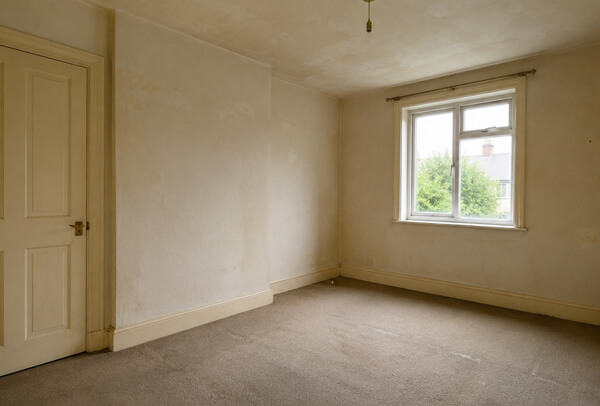 Room in Bedford before redecoration with tired walls ceiling and woodwork