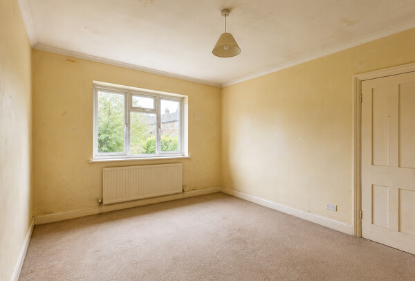 Room in Oxford before full redecoration with tired walls ceiling and woodwork