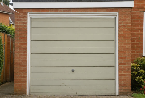Garage door before painting with an older exterior colour
