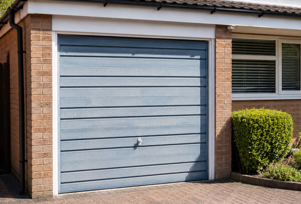 Garage door before painting in Hemel Hempstead with a faded dull finish