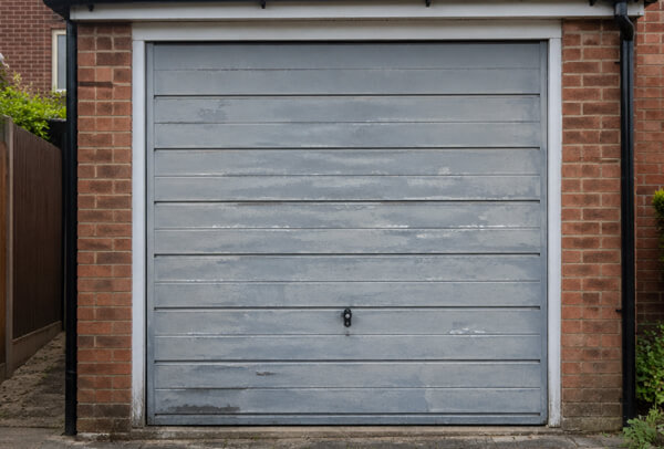 Garage door in Luton before repainting, showing a tired exterior finish
