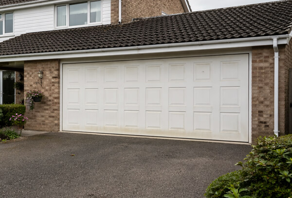Garage door in Northampton before painting, with a tired and weathered finish