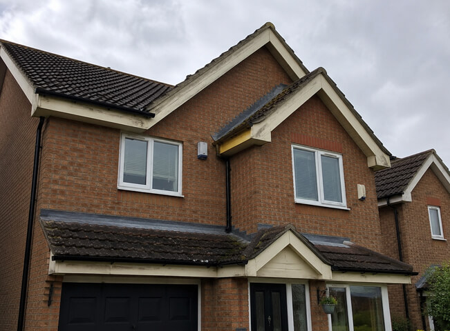 Bargeboard gutter and downpipe before painting in Hemel Hempstead with weathered trim