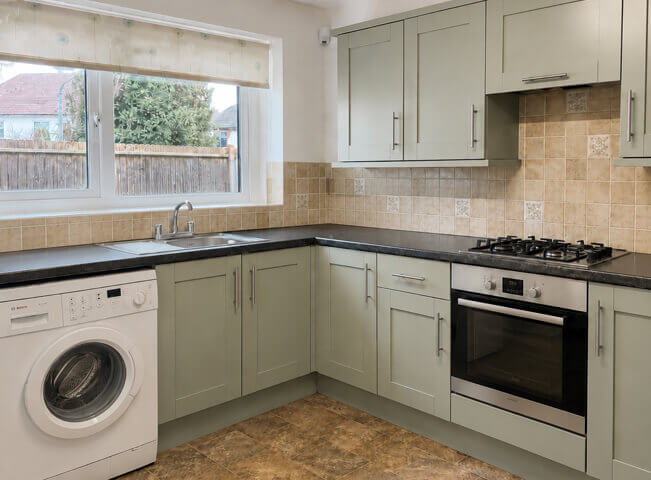 Kitchen cabinets after repainting with a fresh fitted look