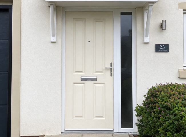 Porch door before painting with a colour that looks tired beside the entrance