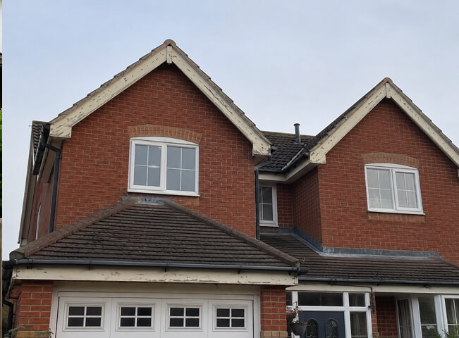 Hemel Hempstead roofline before painting with faded fascias soffits gutters and roof edge trim