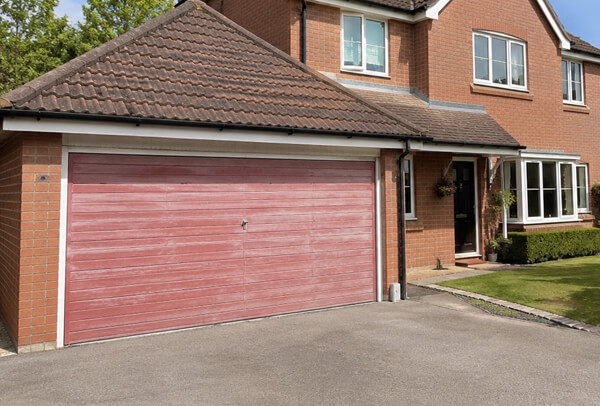 Weather worn garage door before preparation and repainting