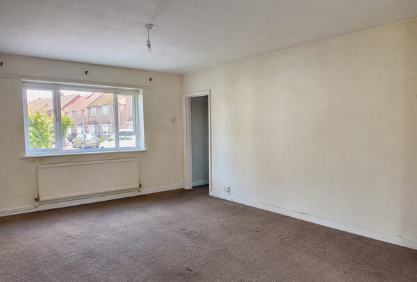 Hemel Hempstead living room before decorating with dull walls and worn painted trim