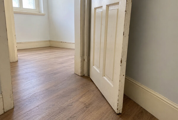 Internal trim in Hemel Hempstead before painting with chipped skirting boards and marked frames