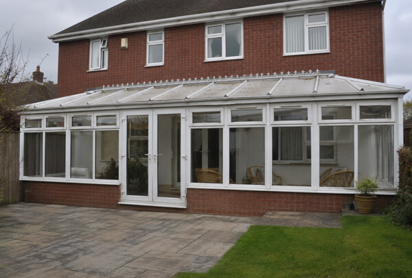 Conservatory before painting in High Wycombe with tired white frames