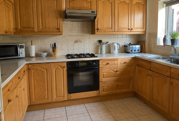 Dated kitchen cabinets before a painted colour update
