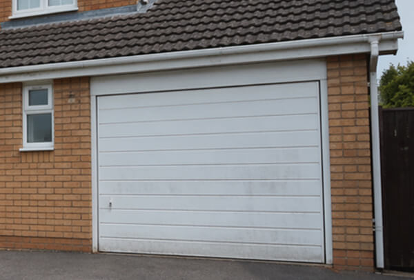 Fibreglass garage door in Northampton before painting, with fading and a tired finish
