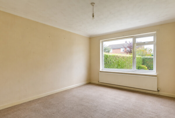Interior room in Luton before decorating with tired walls, dated colour and worn woodwork