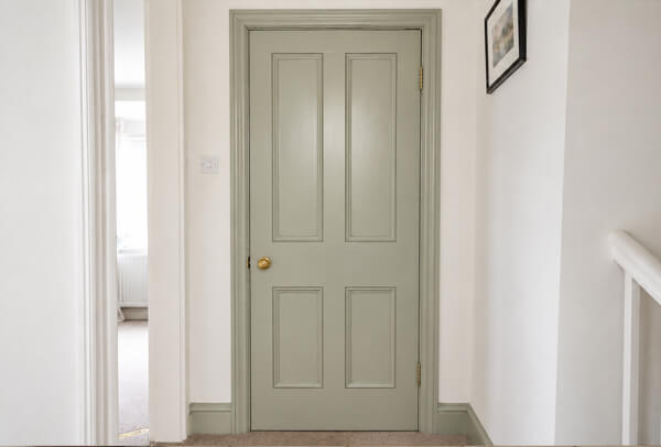 Door after repainting, showing a clean and freshly painted finish