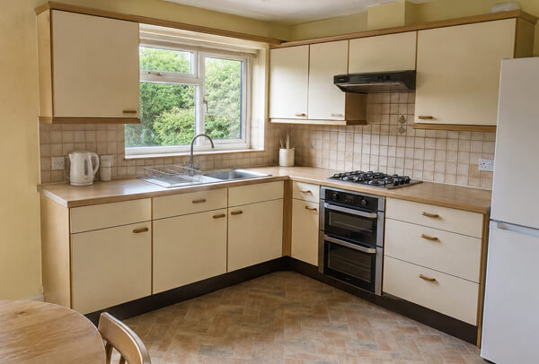 Kitchen in Bedford before cupboard painting and decorating with tired walls and units