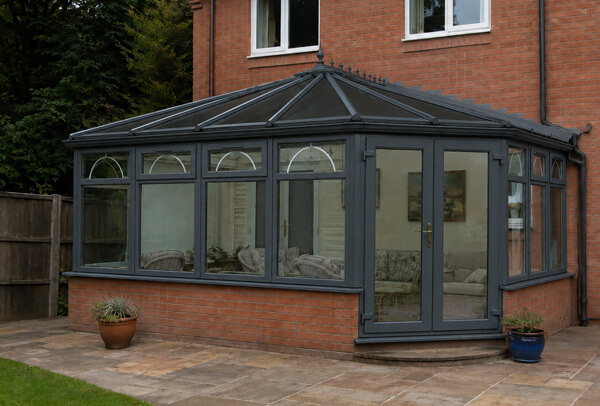 Garden view of conservatory frames after painting in Dunstable