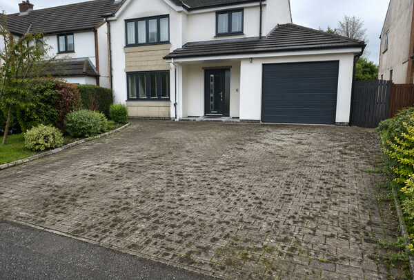 Block paving driveway in Luton before cleaning with dirty joints and weeds