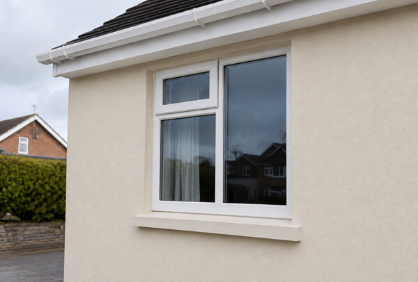 Rendered house wall in Luton after cleaning before repainting is considered
