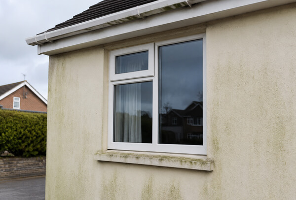 Rendered house wall in Luton before cleaning with staining that may not need repainting