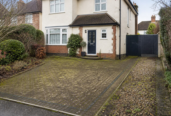 Driveway entrance in Luton before cleaning with moss, weeds and surface staining
