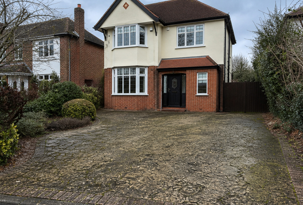 Driveway in Luton before cleaning with plant pots, moss and surface dirt