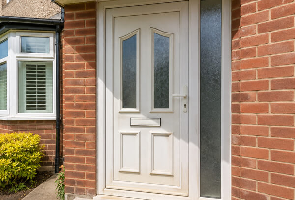 Front door in Luton before painting, with a faded and dated finish