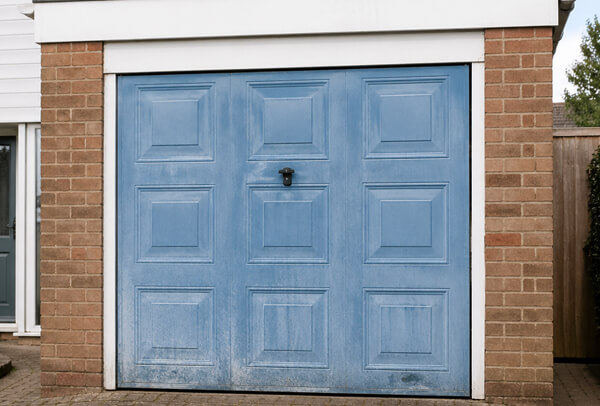 Garage door in Luton before painting, with faded and tired paintwork