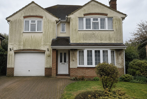 House washing in Luton before cleaning with tired exterior walls and green staining