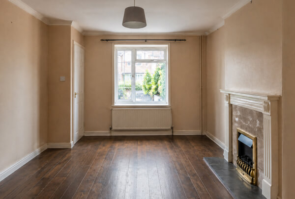 Interior room in Luton before painting and decorating, with tired walls and older finishes